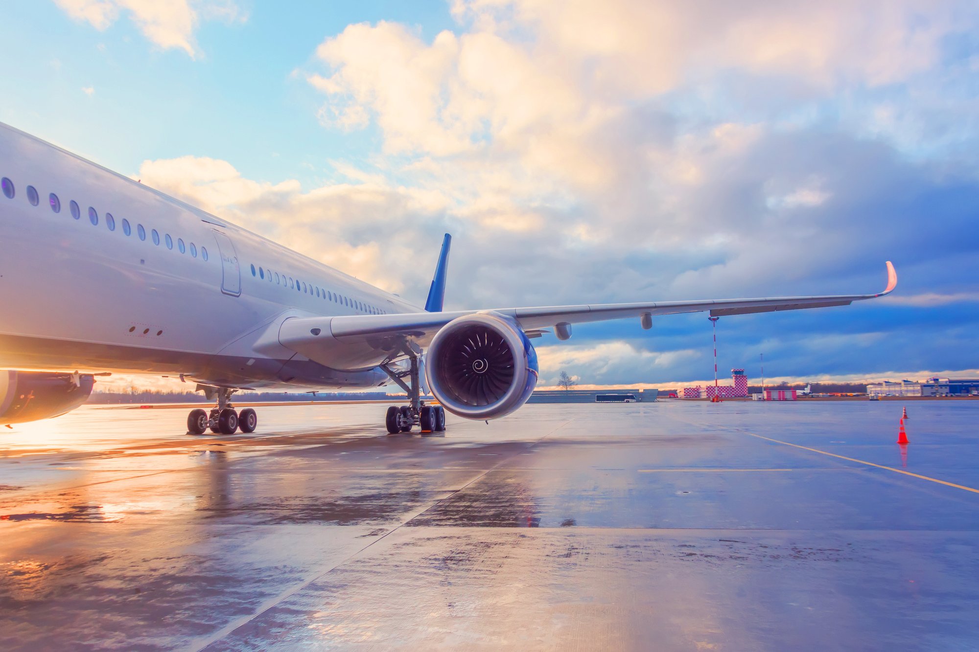 Evening view of a passenger plane wing with engine