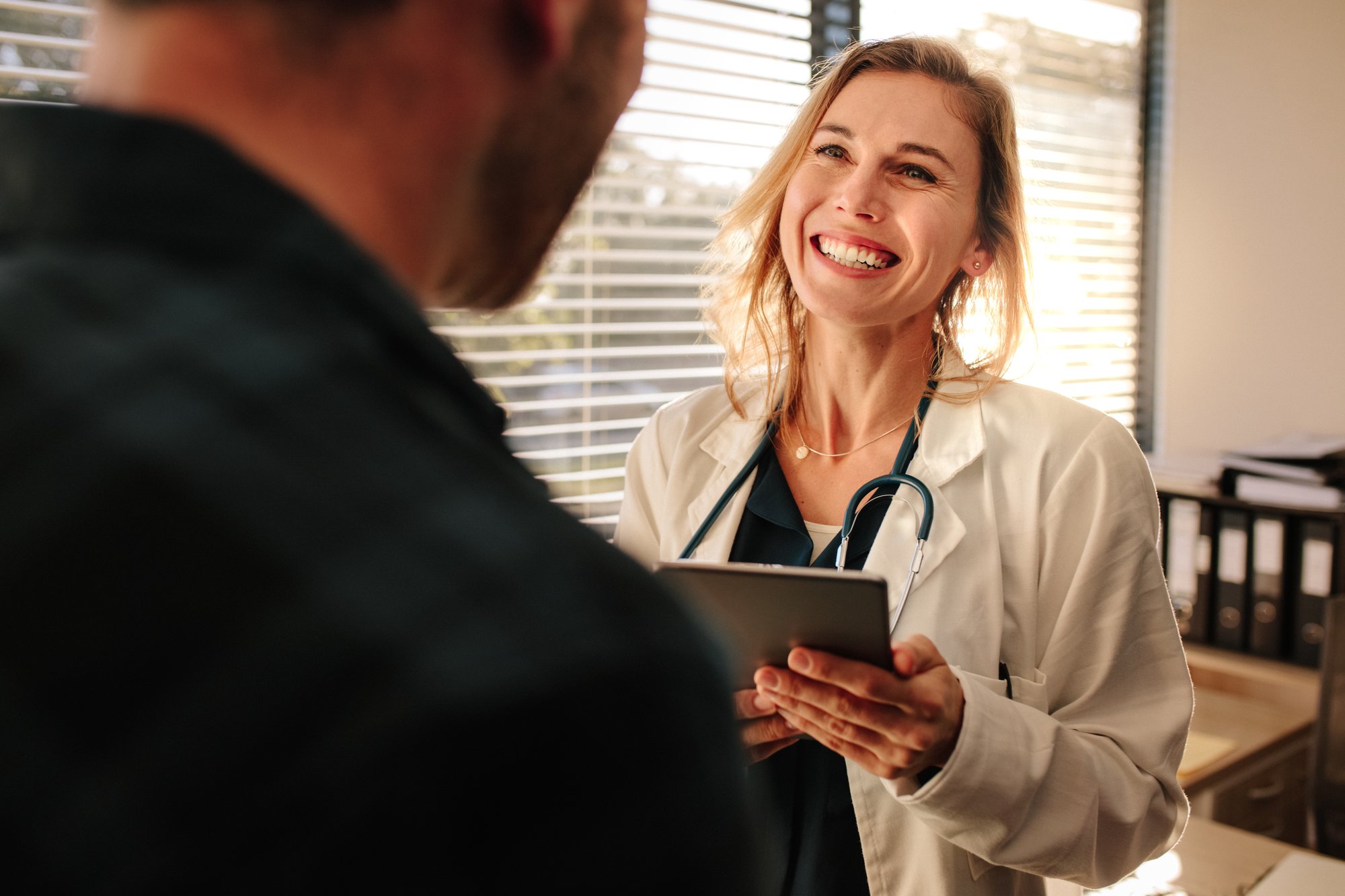 Friendly doctor interacting with her patient