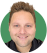 Headshot of Andrew Stanbridge on a green background