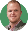 Headshot of Brandon Grant on a green background