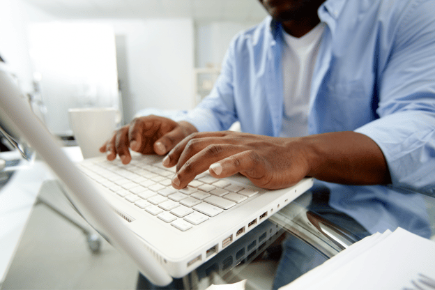 A person working in Microsoft Excel on their laptop.