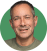 A headshot of Hugh Cumming on a green background