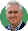 Headshot of Justin Hughes on a green background
