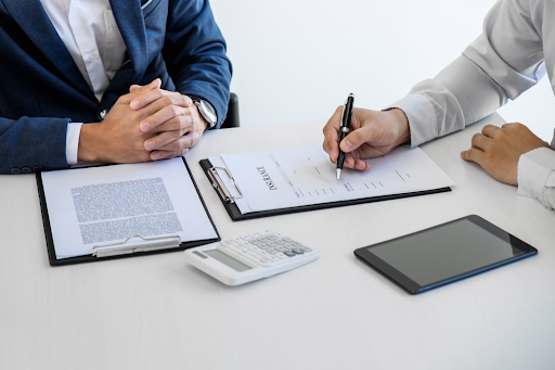A man signing papers for his insurance premium